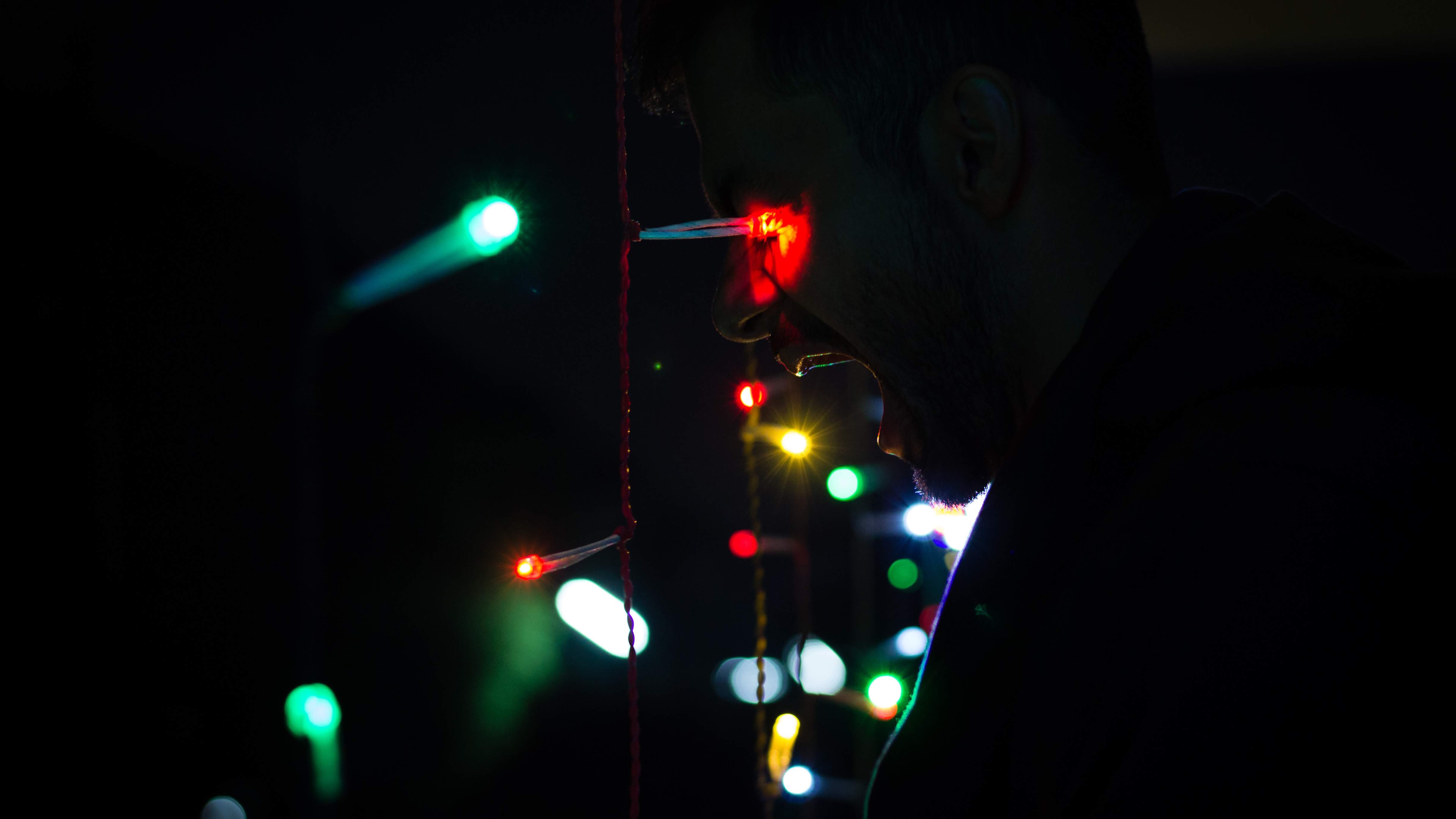 A profile lit by Diwali lights in the dark